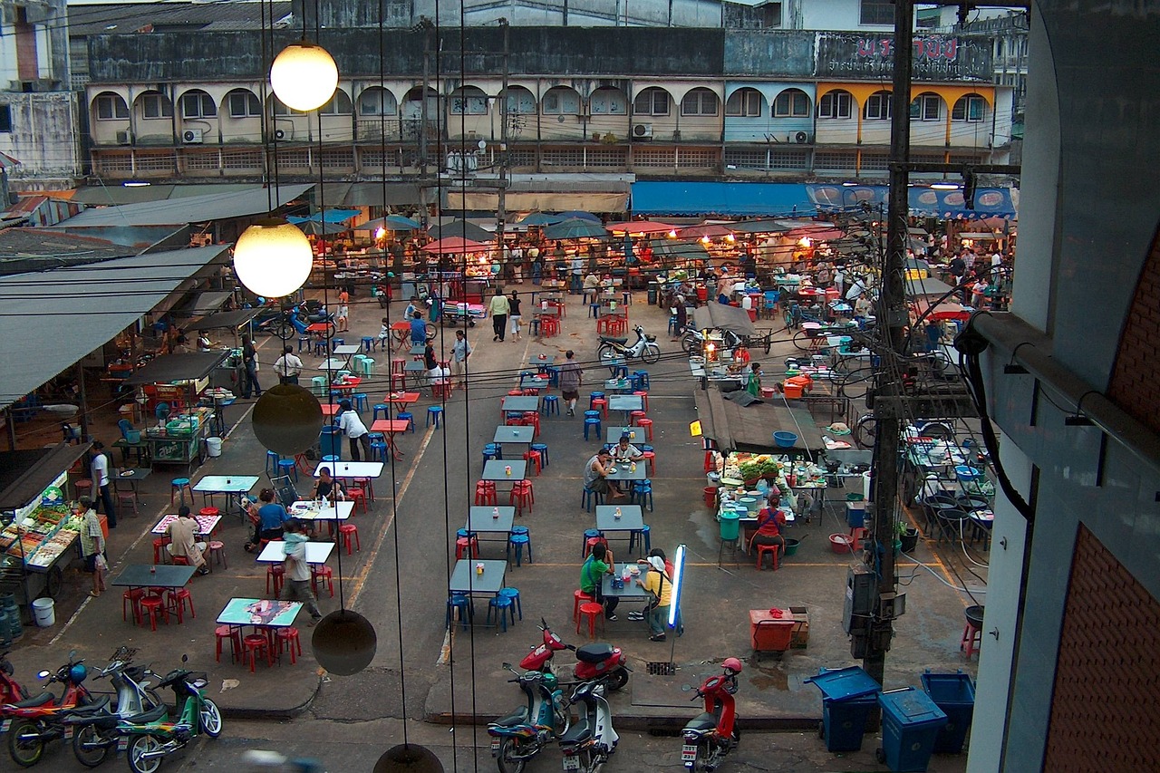 Vendors and shoppers at a busy Thai night market
