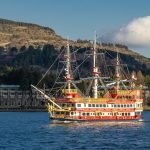 Lake Ashi in Hakone with mountains and a sightseeing ship