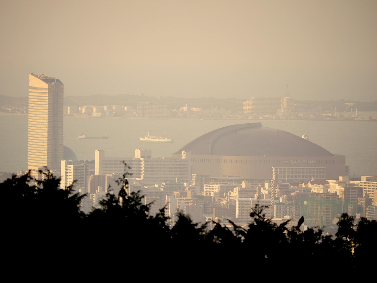 Fukuoka Tower rising over the seaside Momochi district at sunset