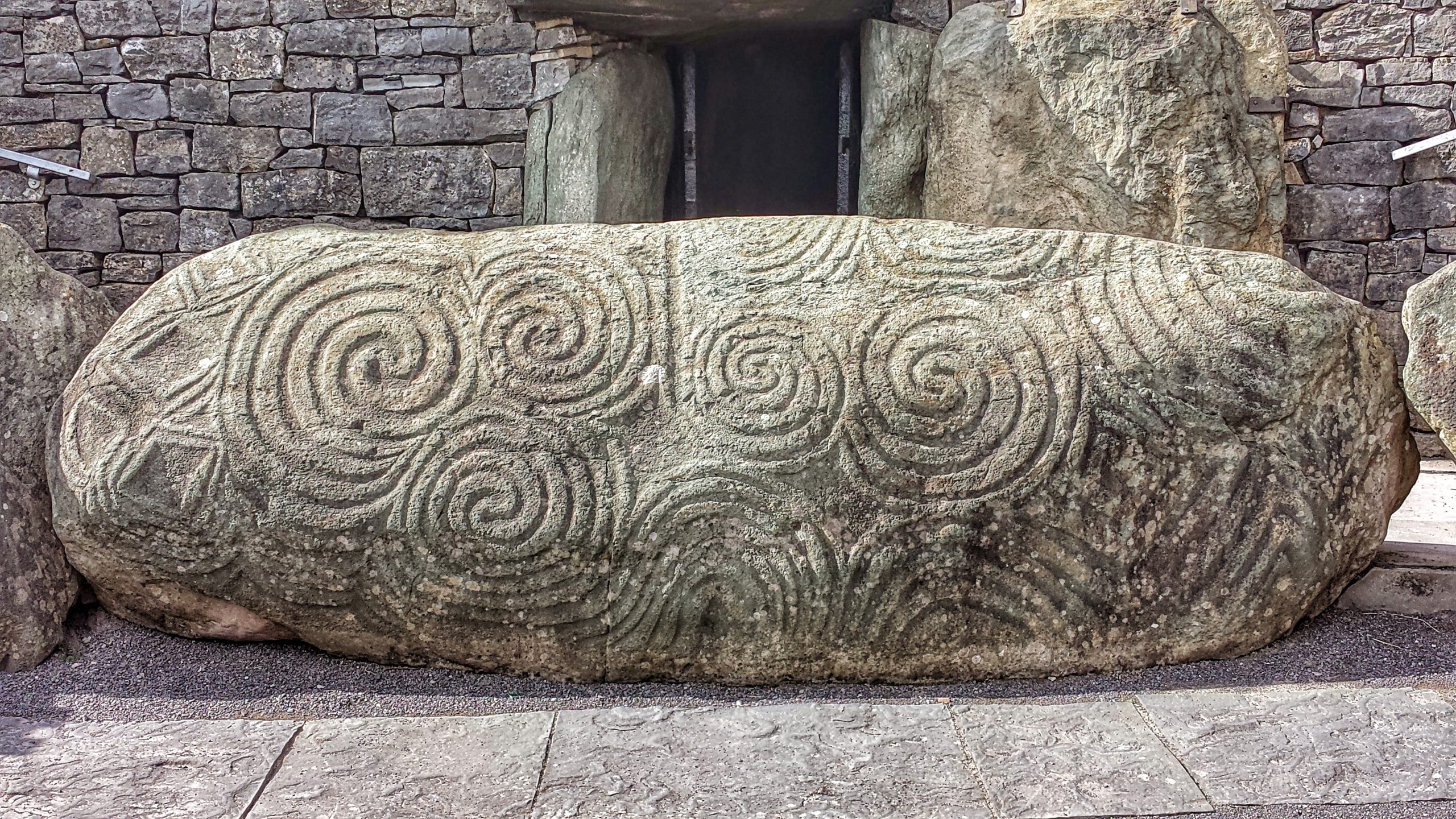 The famous carved entrance stone at Newgrange, with its swirling spirals and geometric patterns. Photo: Wikimedia Commons