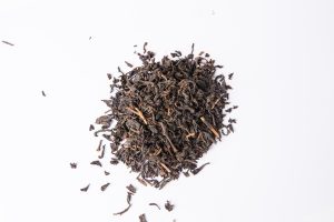 Freshly plucked leaves and brewed Assam black tea