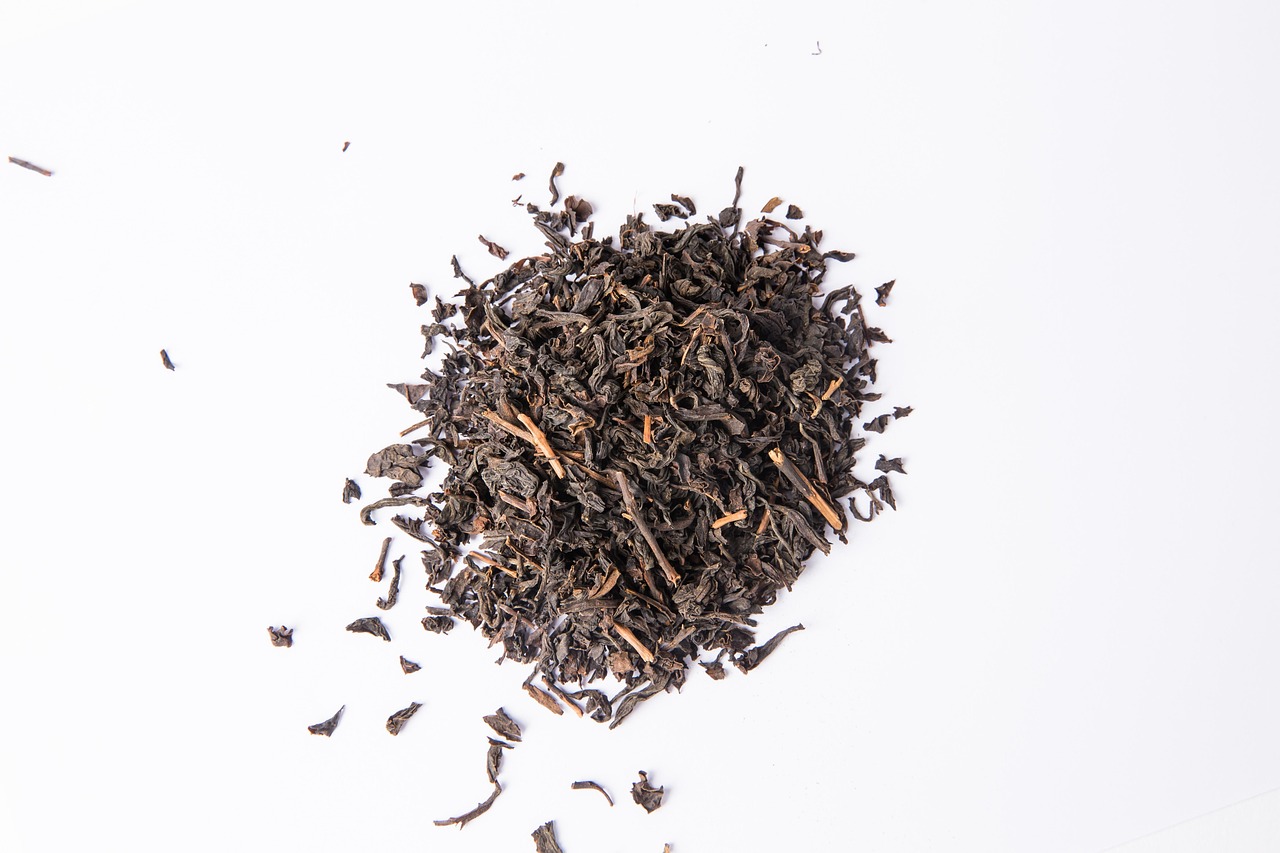 Freshly plucked leaves and brewed Assam black tea