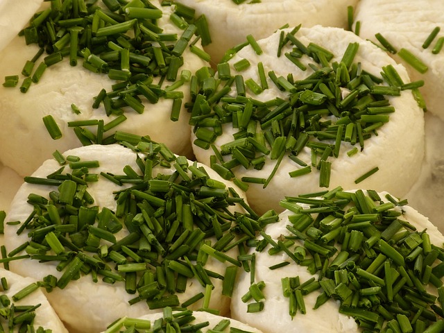 A cheese stall piled high with wheels of cheese