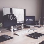 Well-organized coding desk with monitor and laptop