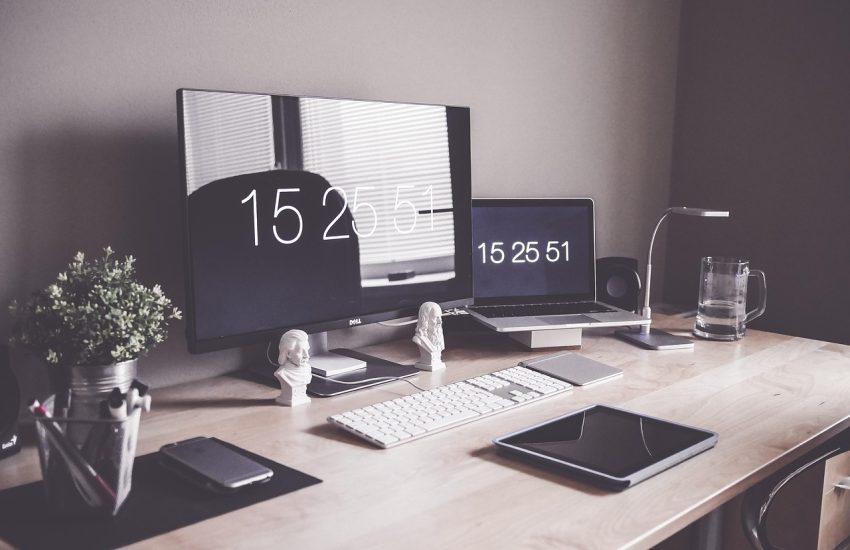 Well-organized coding desk with monitor and laptop