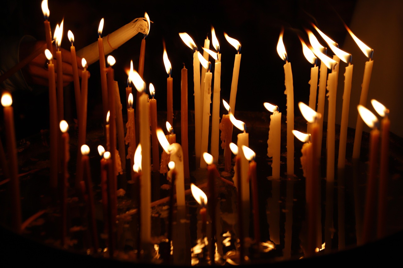 Candles lit by pilgrims in a church