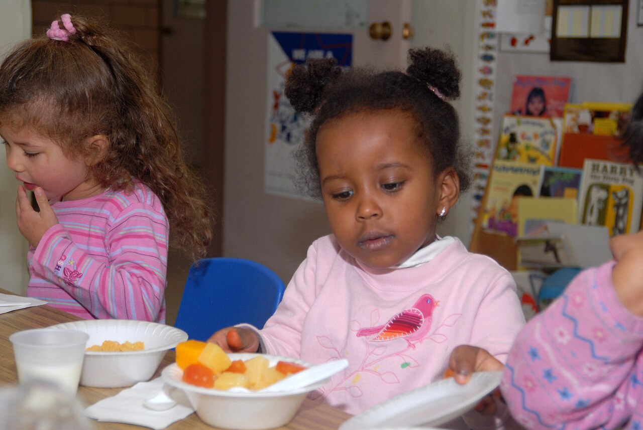 Young children eating a meal together