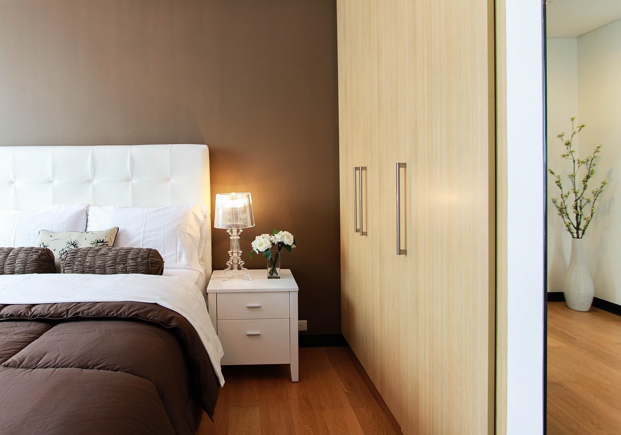Bed positioned to maximize floor space in a small bedroom