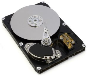 An opened hard disk drive showing its spinning platters