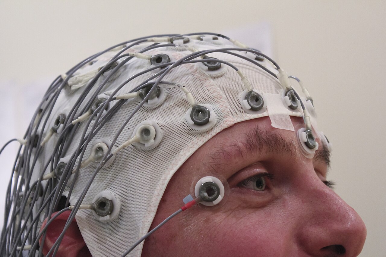 A person wearing an EEG recording cap