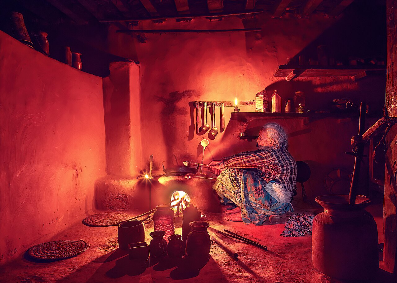 An older woman preparing food in a kitchen