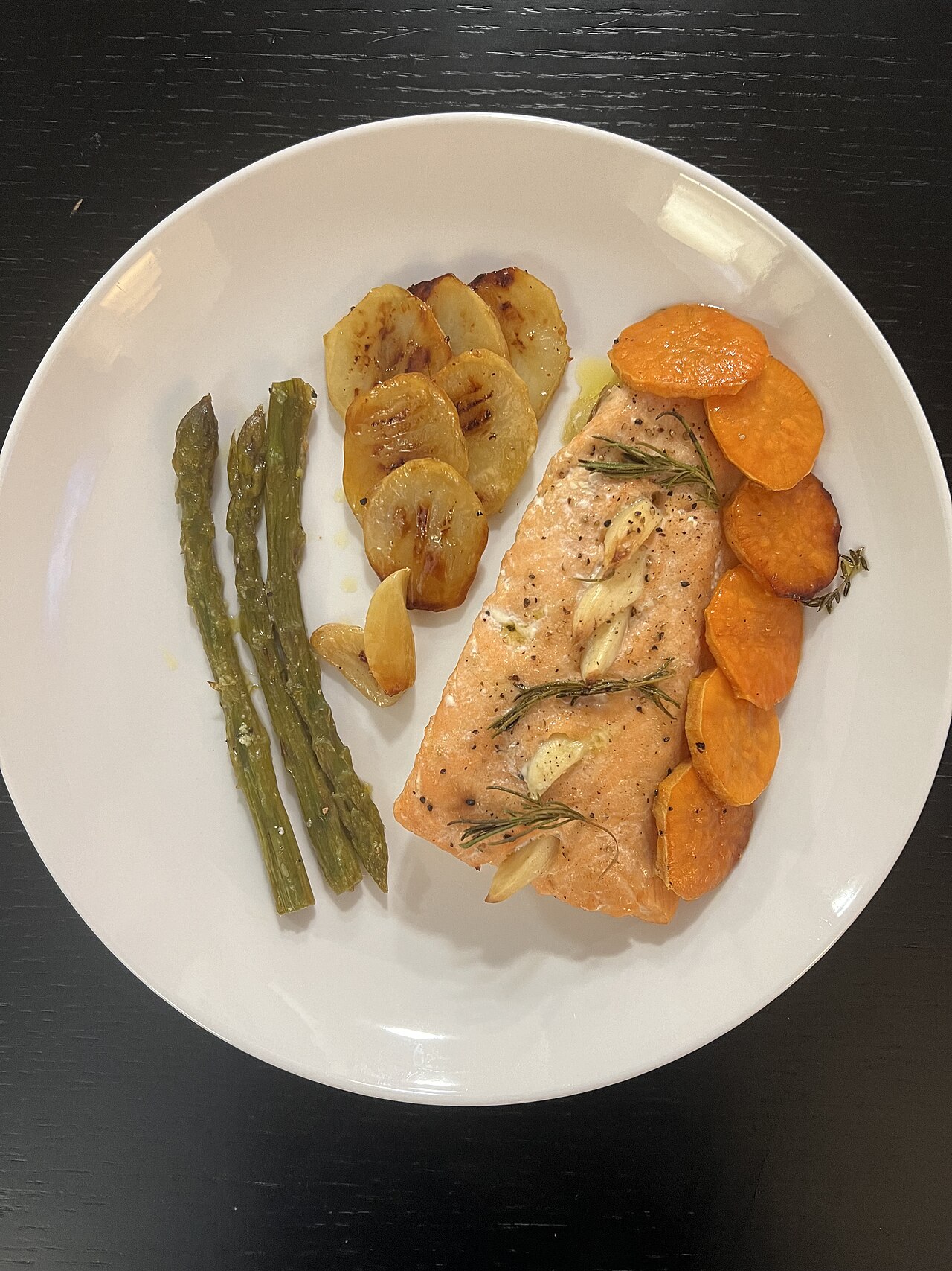 A plate of grilled salmon with vegetables