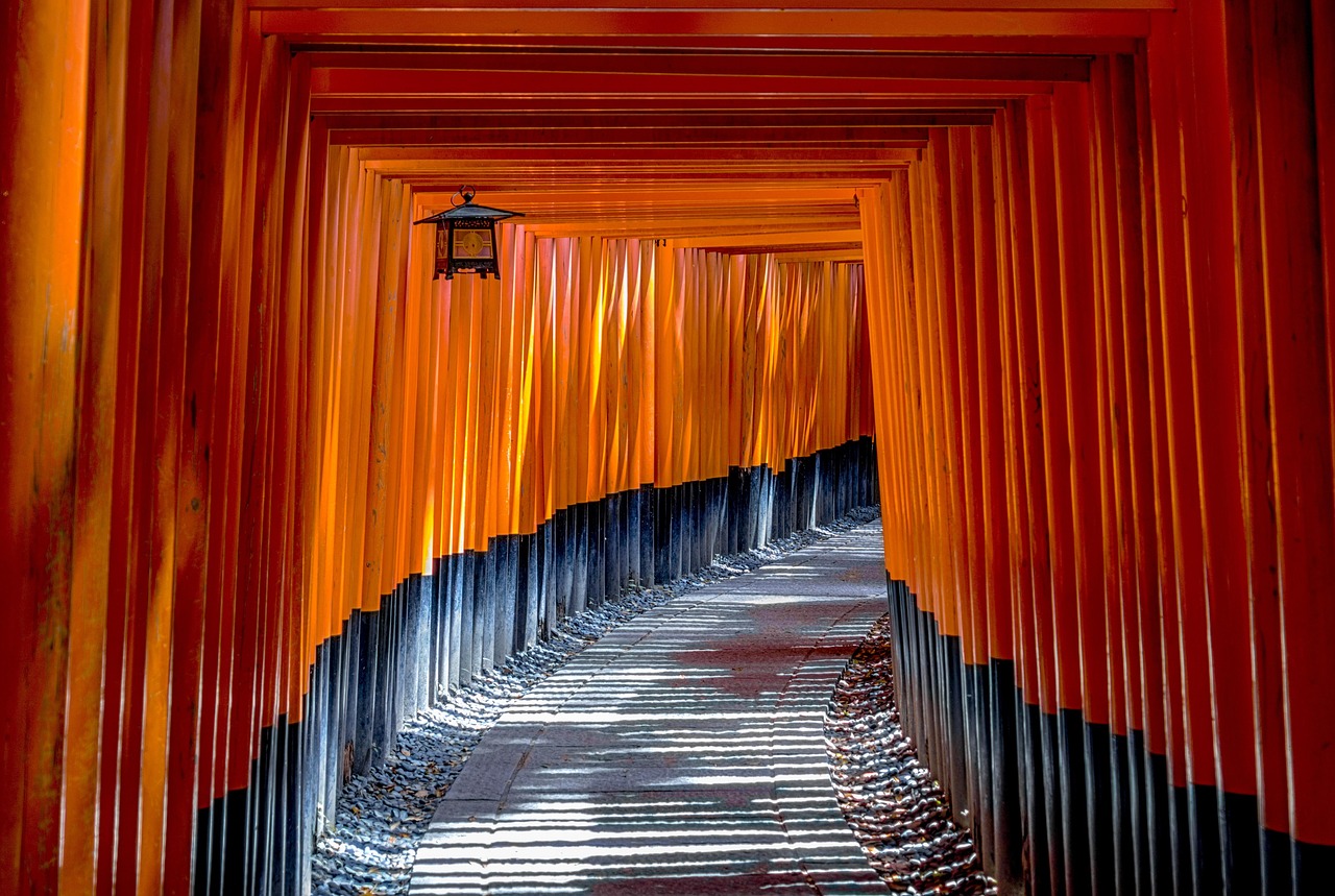 Bright corridor of torii gates at Fushimi Inari shrine