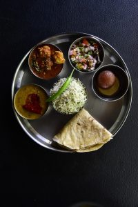 A spread of Indian food in the style of the Gujarati thali