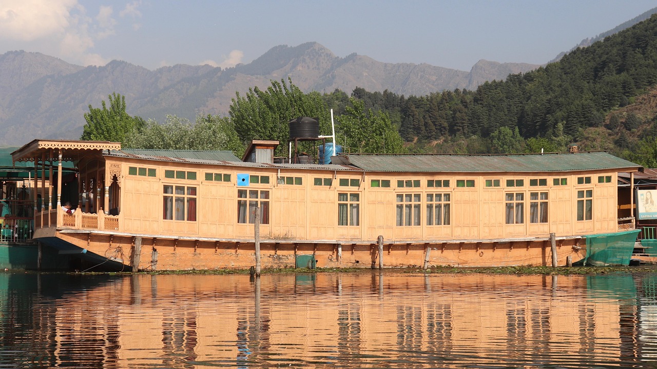 A carved wooden houseboat moored on a Kashmir lake