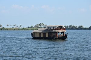 A traditional houseboat drifting through the Alleppey backwaters