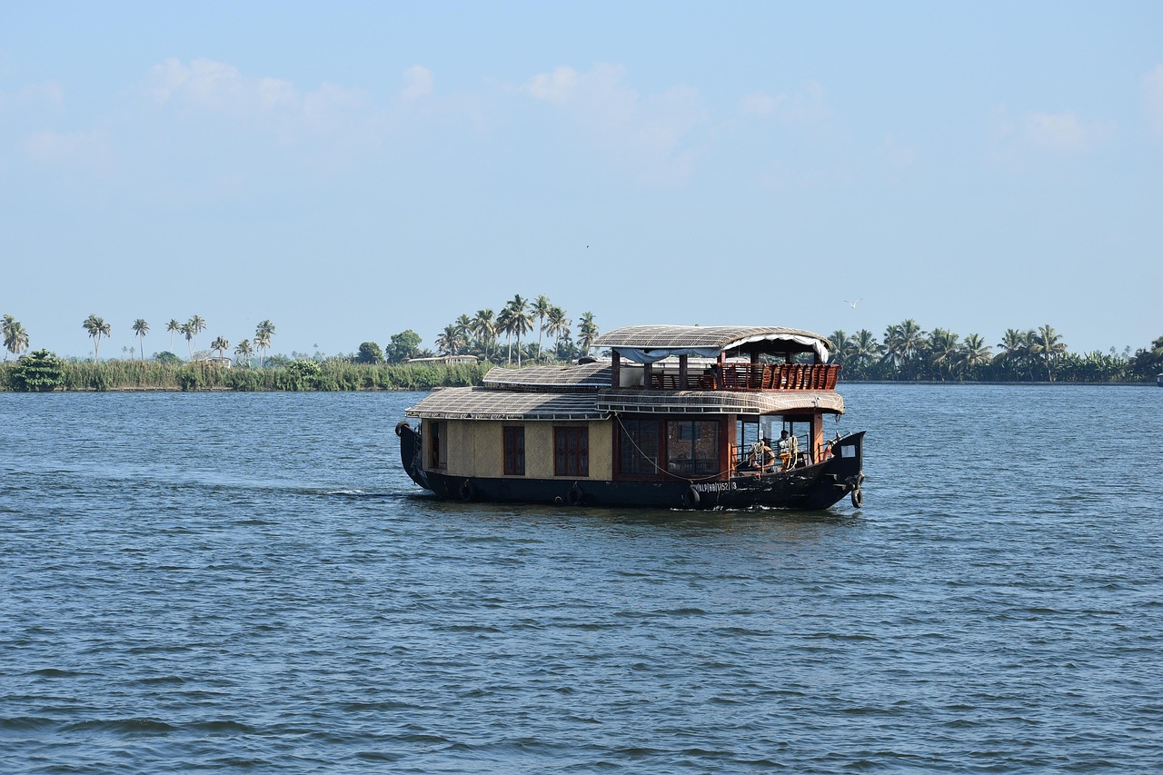 A traditional houseboat drifting through the Alleppey backwaters