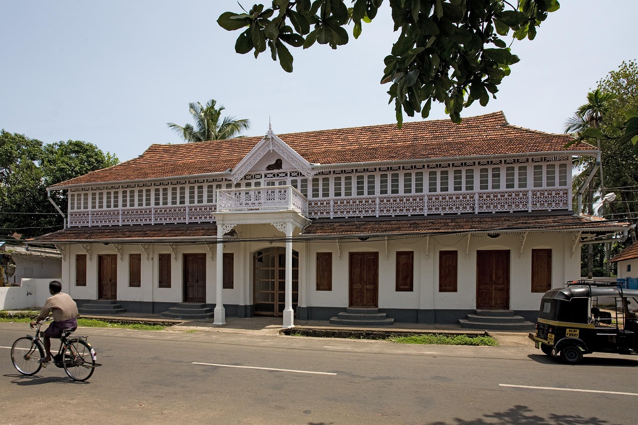 A traditional tiled house among coconut palms in rural Kerala