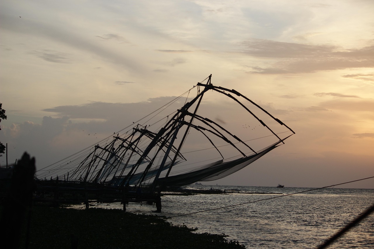 The Chinese fishing nets at Fort Kochi silhouetted against the sky