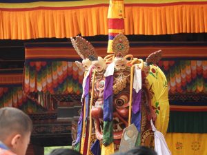 Masked cham dancers at a Bhutanese tsechu festival