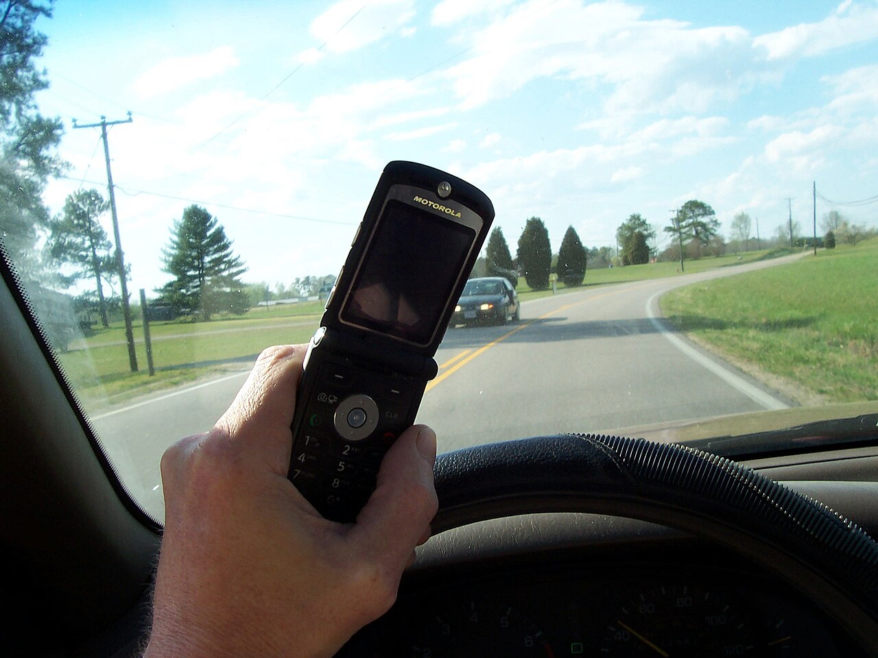 A driver using a phone behind the wheel