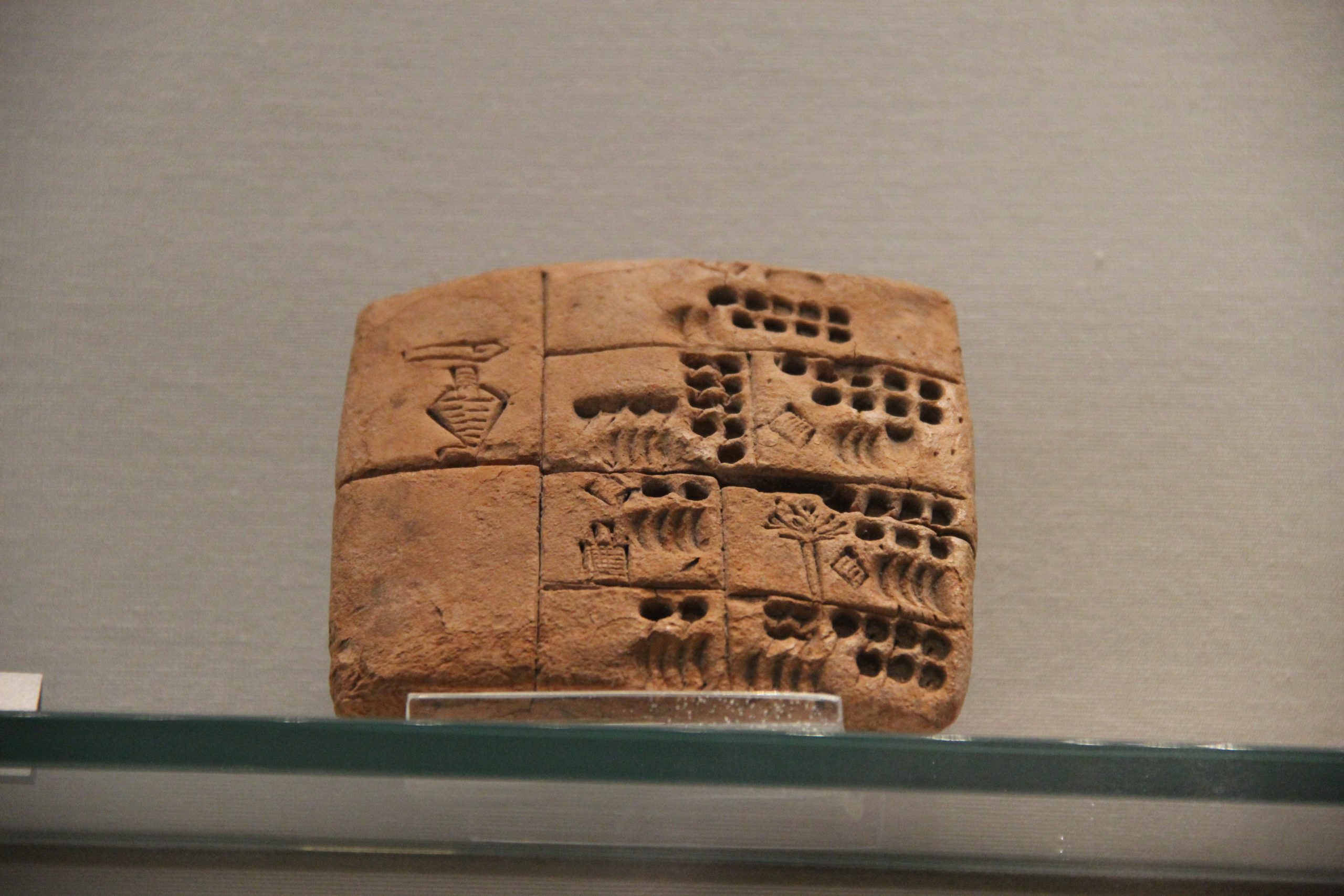 A Sumerian cuneiform clay tablet. The wedge-shaped marks were pressed into wet clay with a reed stylus — the world’s first writing system.