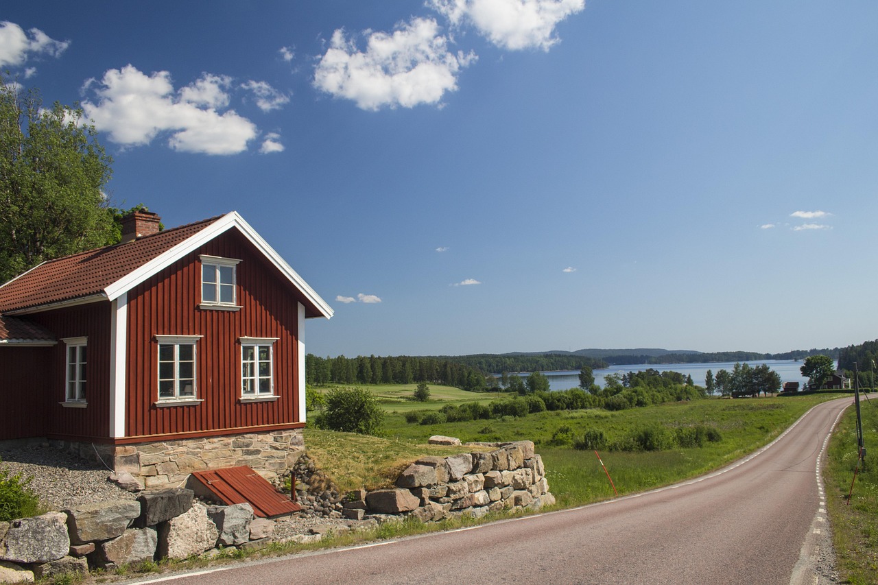 Open Swedish countryside in summer, with forest, water, and the long northern light