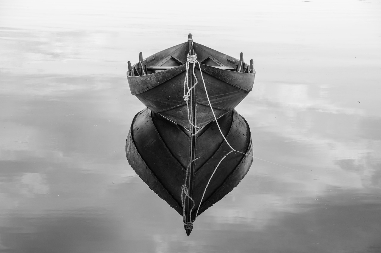 A calm lake with a still mirror-like reflection