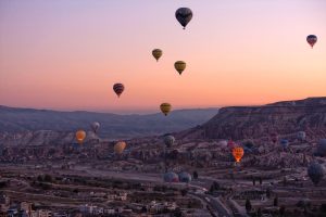 Hot air balloons drifting over the volcanic valleys of Cappadocia in central Anatolia, the heartland of the Turkish republic.