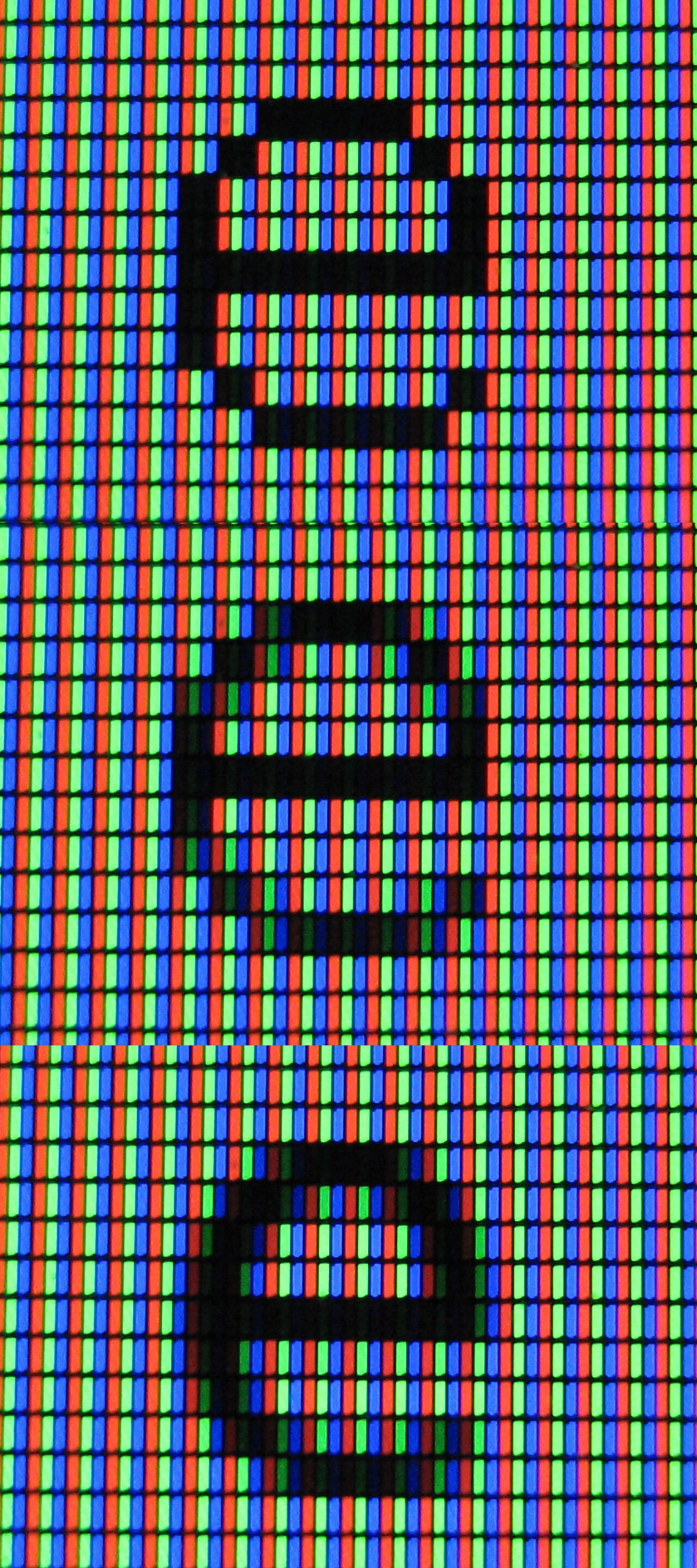 A close-up showing the red, green and blue sub-pixels of a screen