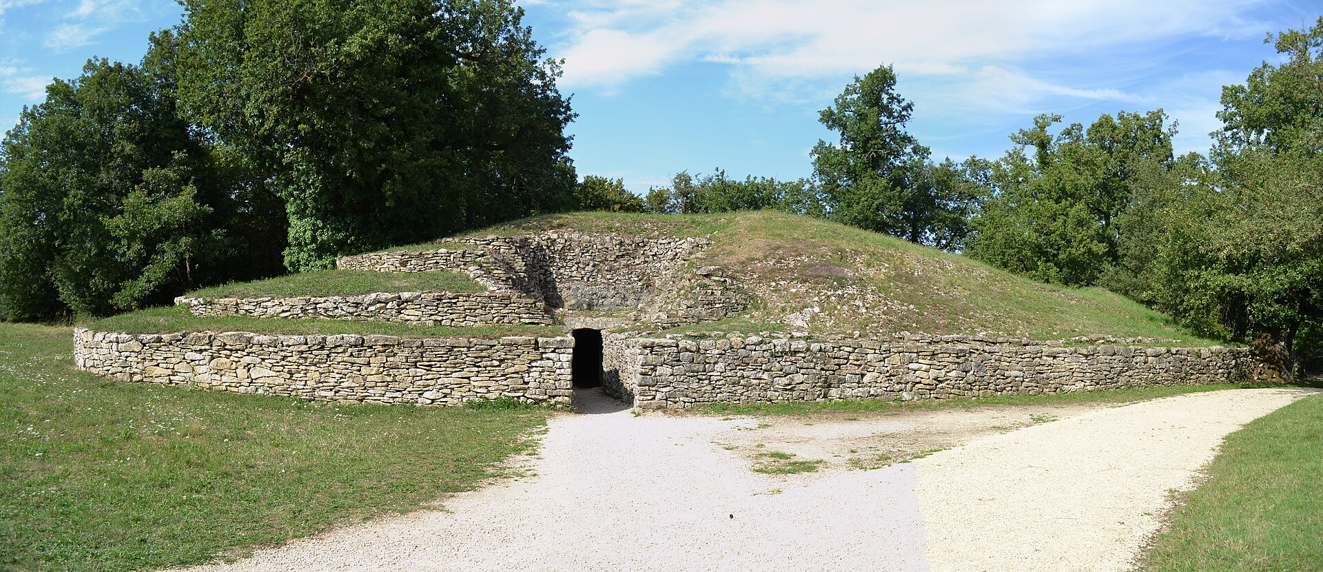 The stepped mound of Tumulus A rising from the Bougon necropolis