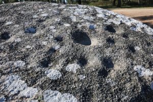 Cup-shaped dimples carved into the surface of one of the stones
