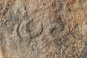 Faint engravings still visible on the granite after thousands of years