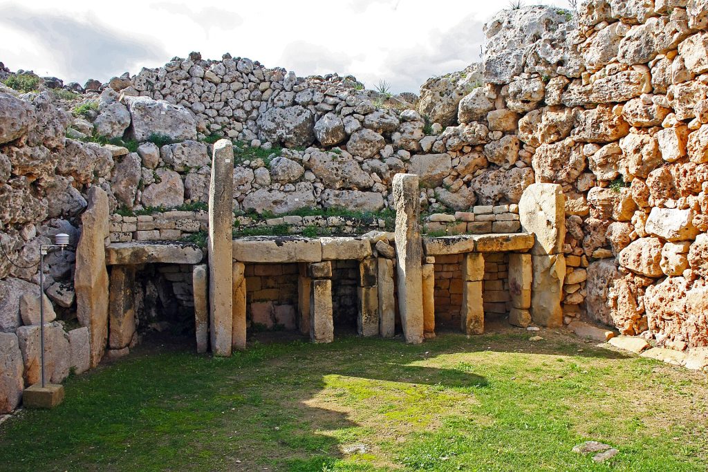 The massive facade of the Ġgantija temples rising above the Gozo countryside
