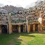 The massive facade of the Ġgantija temples rising above the Gozo countryside