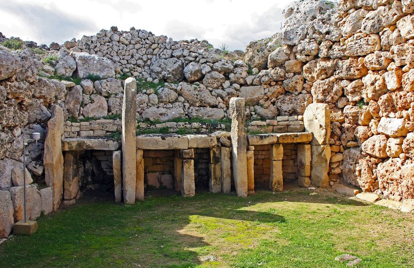 The massive facade of the Ġgantija temples rising above the Gozo countryside