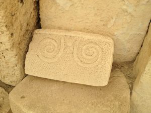A stone panel carved with the spiral motif typical of Malta’s temples