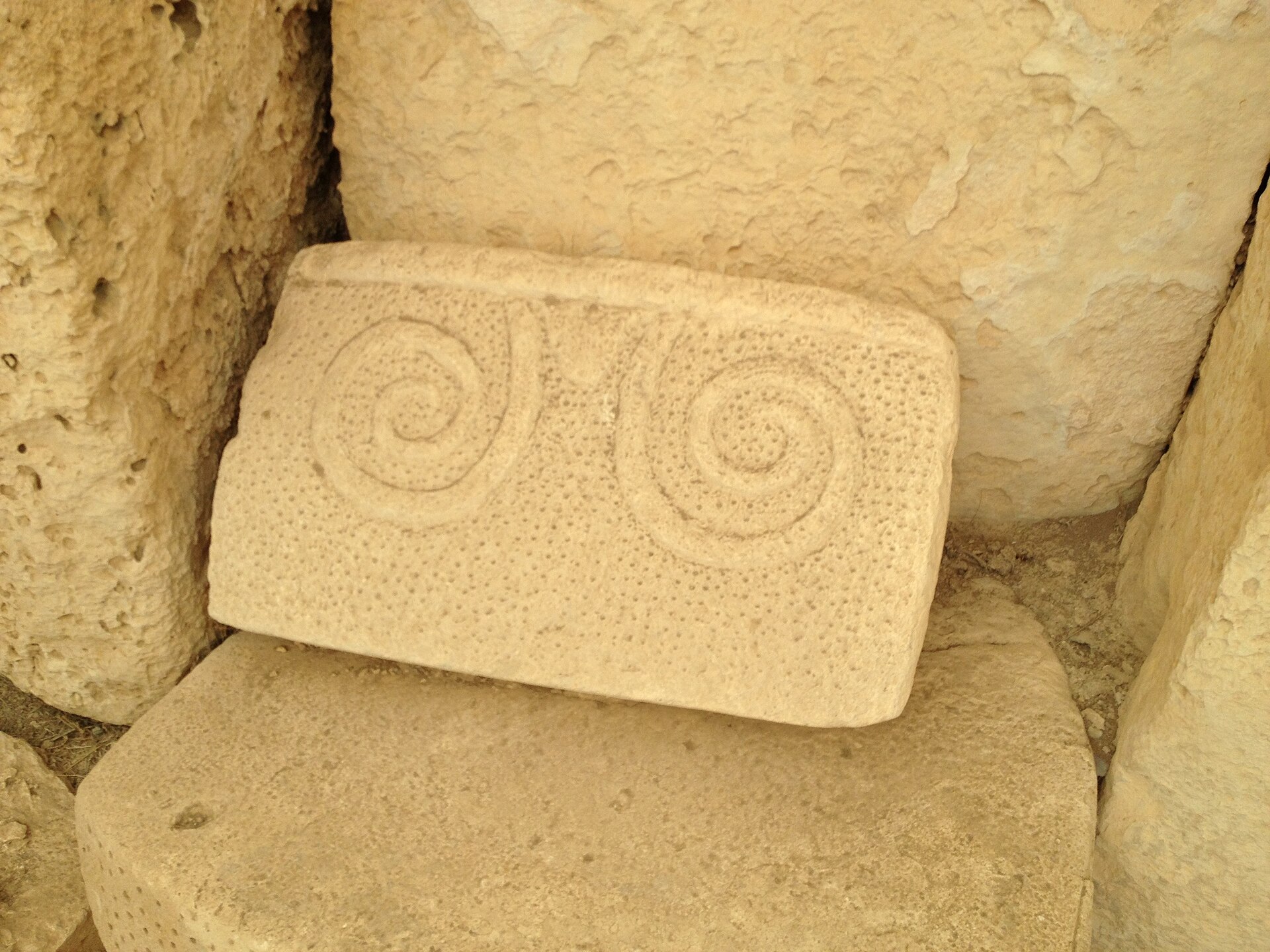 A stone panel carved with the spiral motif typical of Malta’s temples