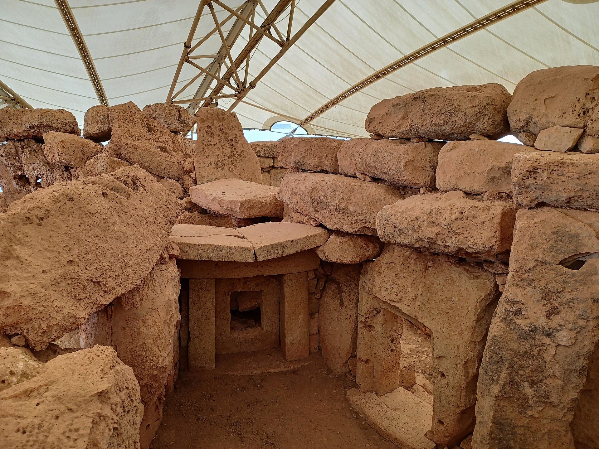 A passage between chambers lined with massive worked stones