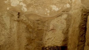 An animal frieze carved in low relief along one of the great megaliths