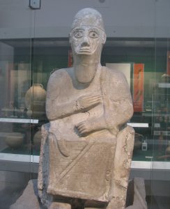 The seated statue of King Idrimi of Alalakh covered in cuneiform text