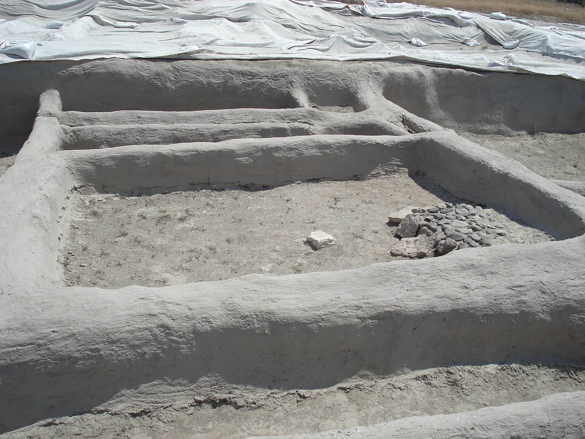 A closer look at a single hearth, worn by the cooking fires of a family who lived here ten thousand years ago.