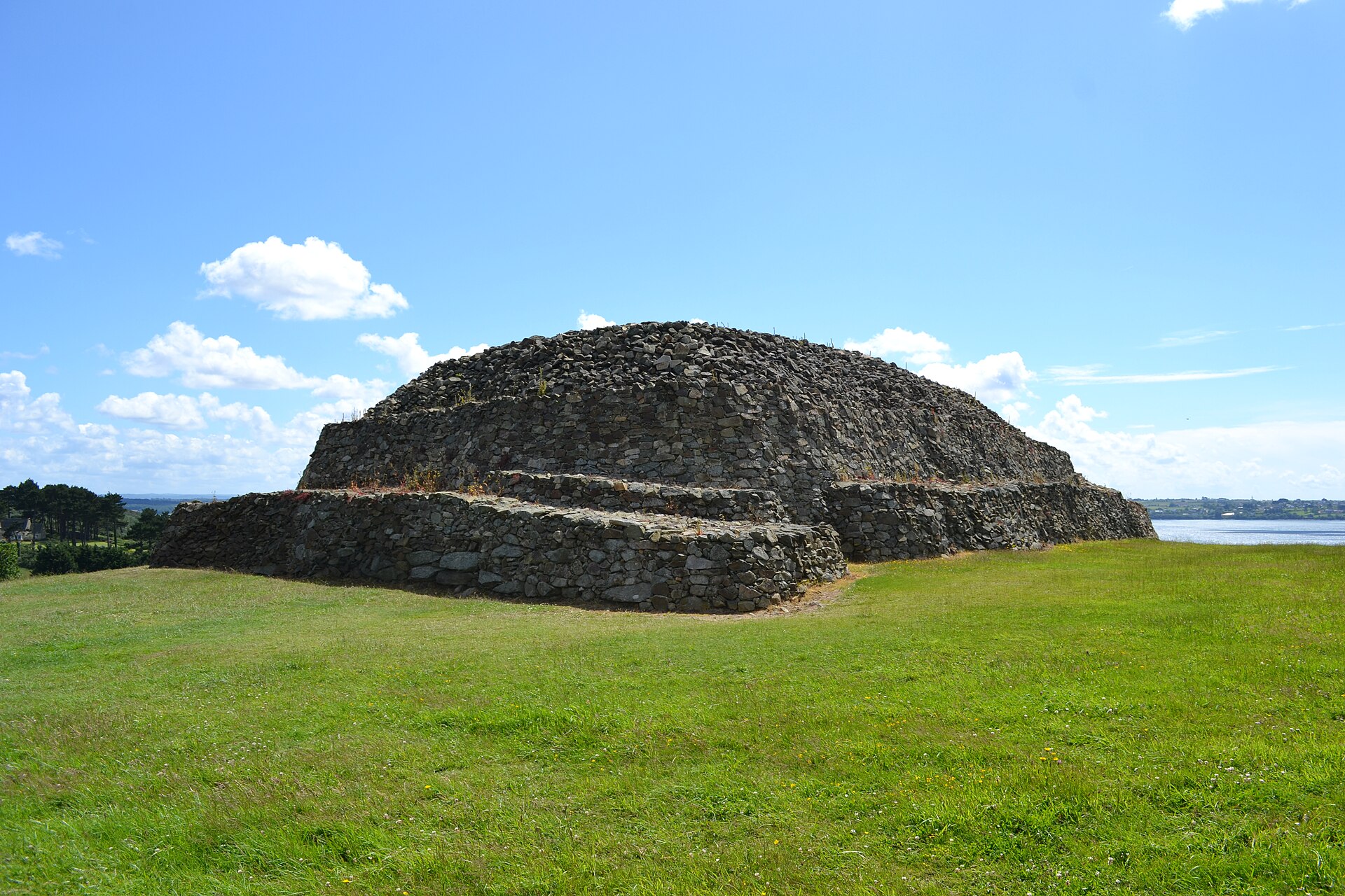 The rear side of the massive drystone Cairn of Barnenez