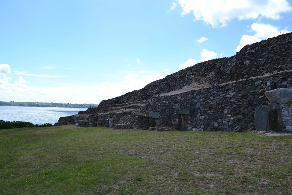 The long stepped stone facade of the Cairn of Barnenez seen from the front