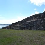 The long stepped stone facade of the Cairn of Barnenez seen from the front
