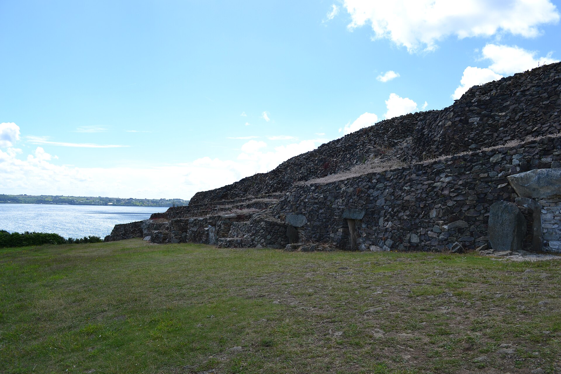 The long stepped stone facade of the Cairn of Barnenez, one of the oldest monuments in Europe