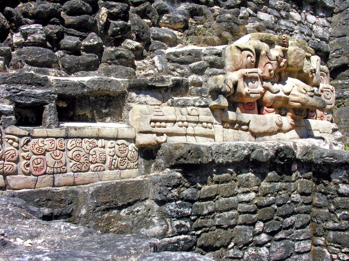 Stucco mask and hieroglyphic inscription on the Caana pyramid at Caracol