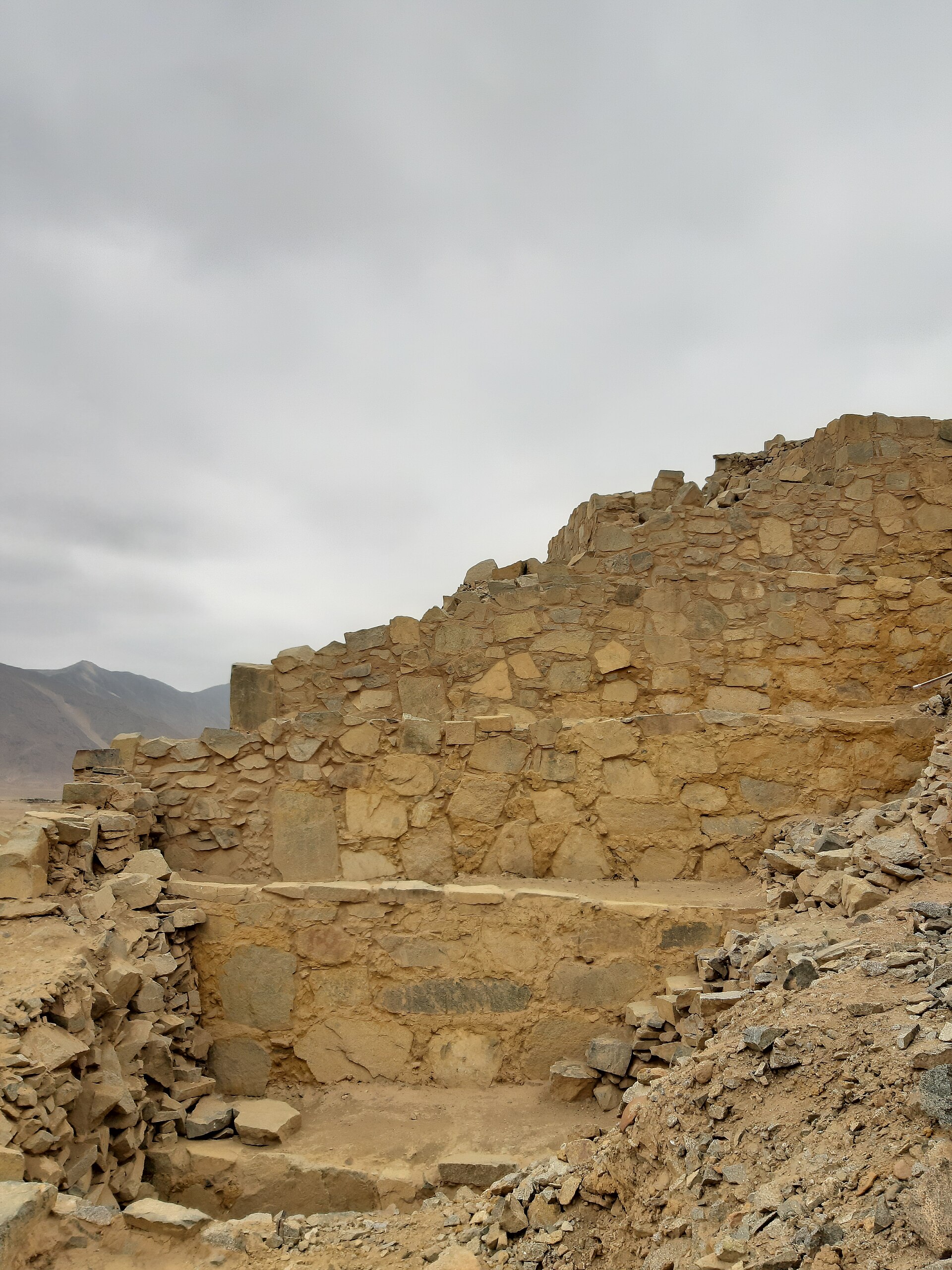 One of the great stepped pyramid platforms of Caral, its tiers and retaining walls still standing after five thousand years in the desert.