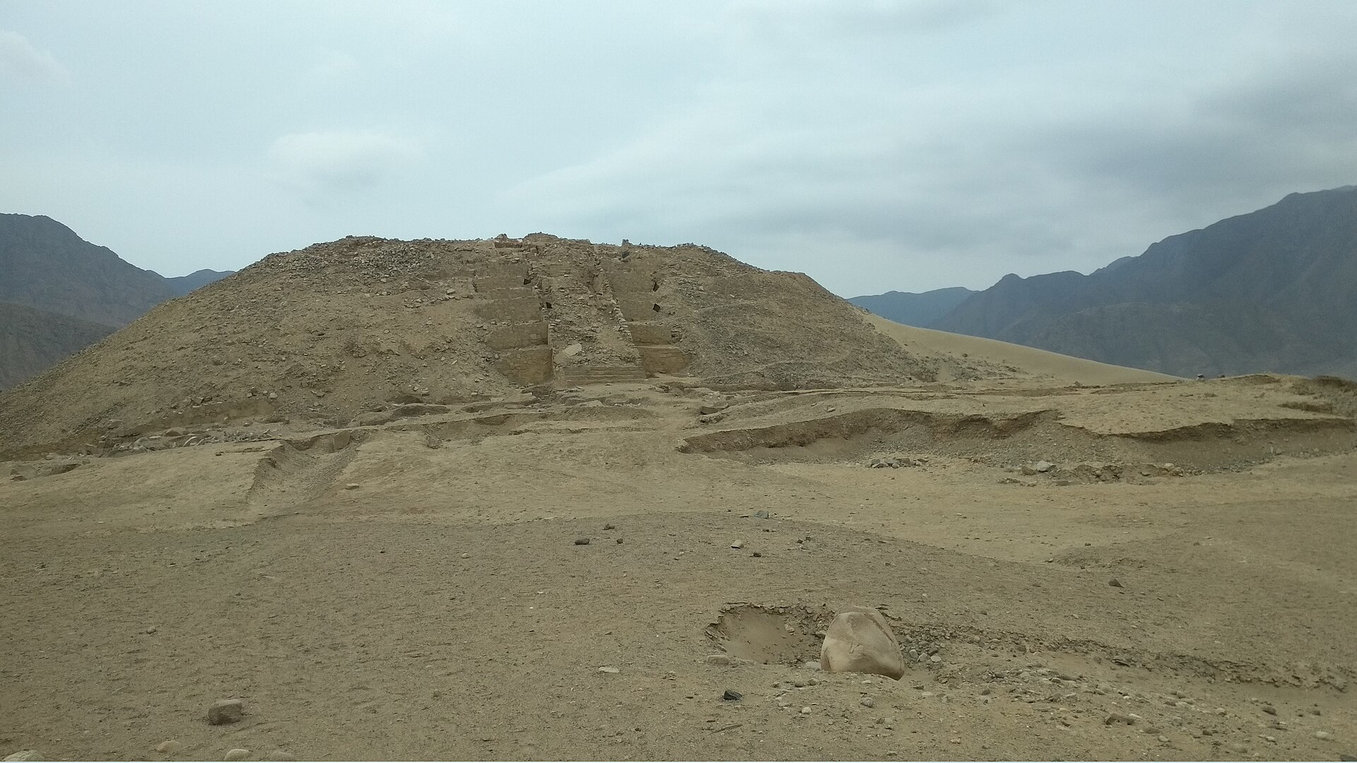 A stepped pyramid rising above the plazas of Caral, one of the six great mounds that dominate the ancient city.