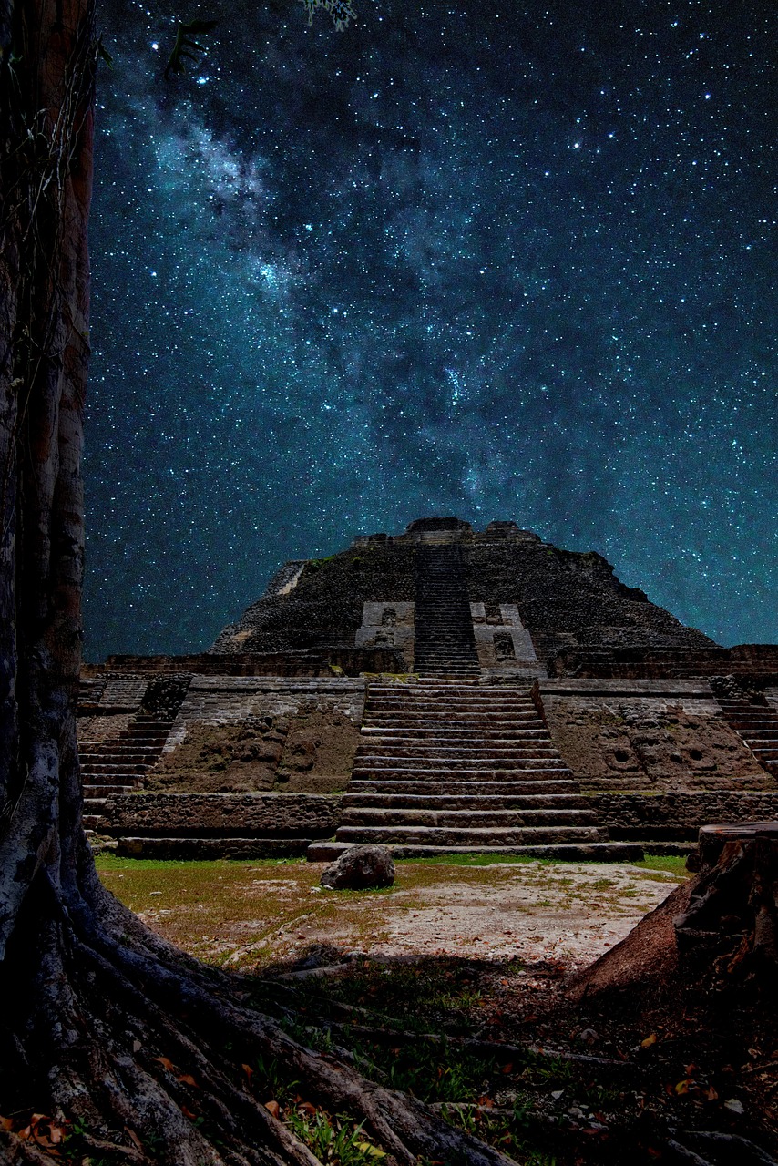 A stone Maya temple lit at dusk